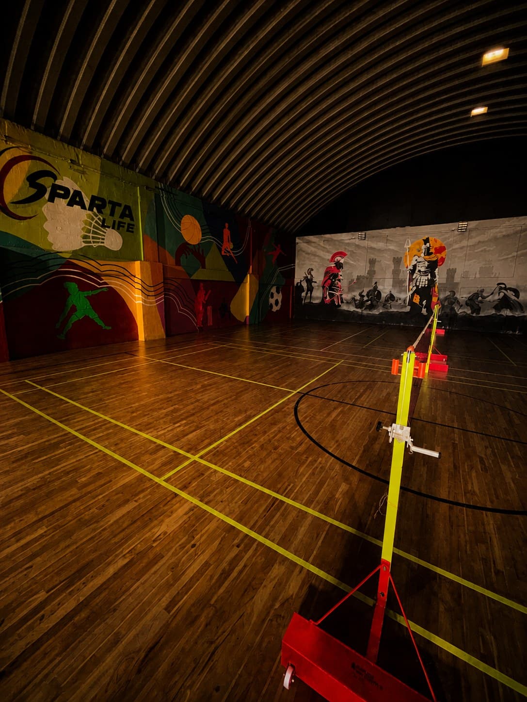 Badminton court at Sparta Life, Kolegaon, under the studio mural